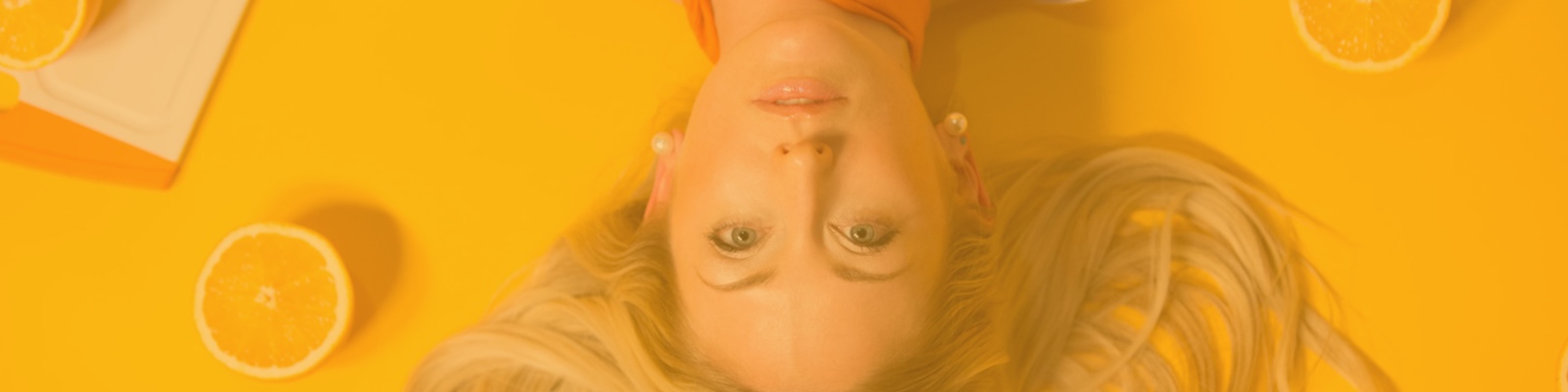 Picture of sophie upside down in front of a yellow background